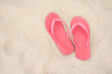 Fototapeta na wymiar Red old slippers on the beach