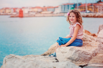 Fototapeta na wymiar child girl relaxing on seaside on summer vacation in Piran, Slovenia