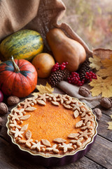 Homemade seasonal pumpkin tart pie with cute decoration on top