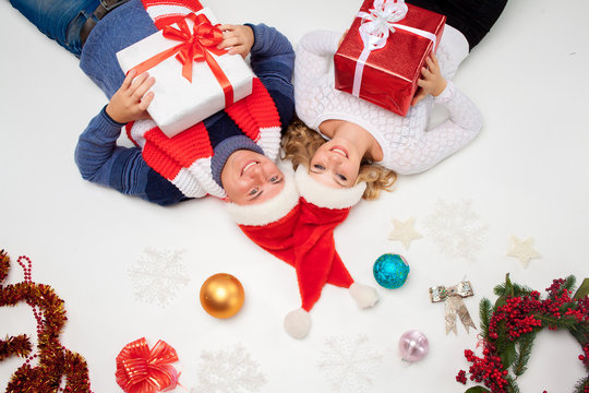 Lovely christmas couple lying with presents