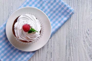 Delicious cupcake with berries on table close up