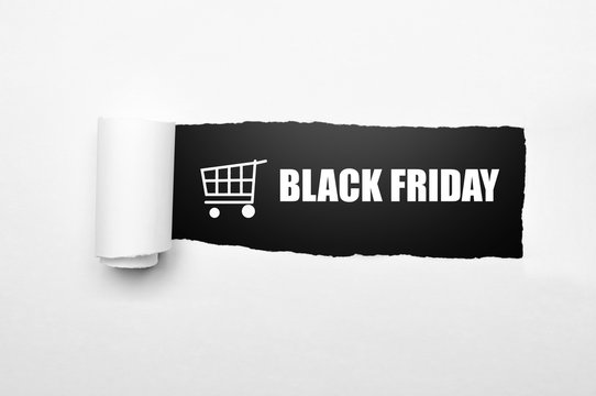 Shopping cart and black friday text on paper tear