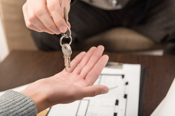 Broker gives key from apartment to customer