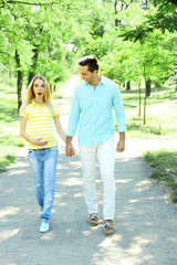 Fototapeta premium Young pregnant woman with husband walking in park