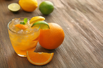 Glass of orange juice on wooden background