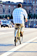 Rear view of bicyclist on his way home in the evening sun