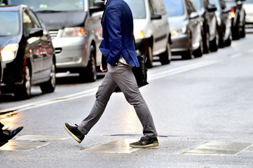 Suit (man) in silhouette walking on the street.