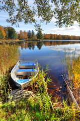 Vertical autumn landscape with aluminium boat © Piotr Wawrzyniuk