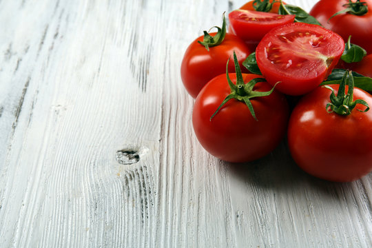 Red tomatoes on wooden background