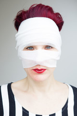 portrait of woman with bandages wrapped around her head