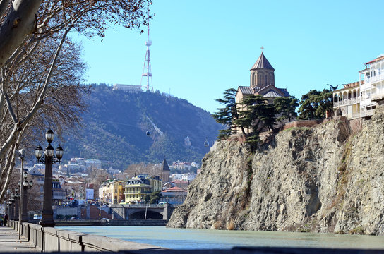 Brae of Mtkvari in Metekhi district of Tbilisi. Assumption Church on the rock over the River and Mtatsminda mountain on the background 