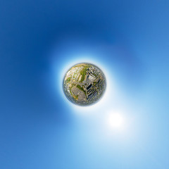 Aerial view of downtown. Crossroads, houses, buildings and parks. Little planet sphere