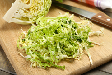 Cut savoy cabbage on wooden cutting board