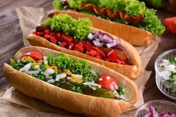Hot dogs and vegetables on craft paper closeup