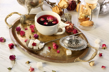 Hot rose tea on metal tray