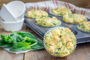 Freshly baked snack muffins with spinach and feta cheese
