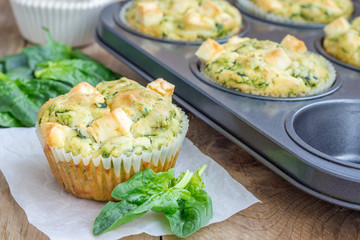 Freshly baked snack muffins with spinach and feta cheese