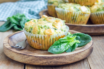 Snack muffins with spinach and feta cheese on a wooden plate