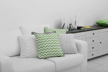 Sofa with colorful pillows in room