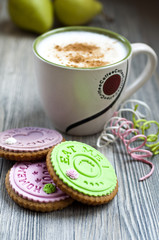 Cup of coffee with homemade decorated cookies