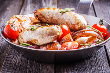Grilled sausages and vegetables  in  rustic style.