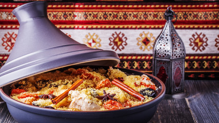Traditional moroccan tajine of chicken with dried fruits and spi