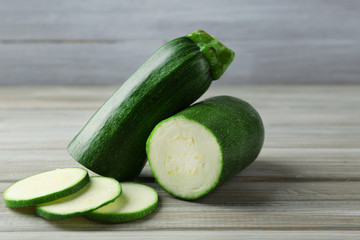 Fresh zucchini on wooden background