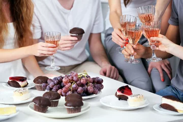 Peel and stick wall murals Dessert Friends hands with glasses of wine and desserts, close up