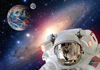 Astronaut spaceman helmet outer space moon planet Earth globe. Elements of this image furnished by...