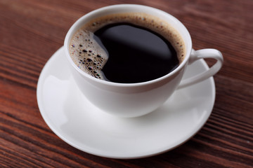 Cup of coffee on wooden background