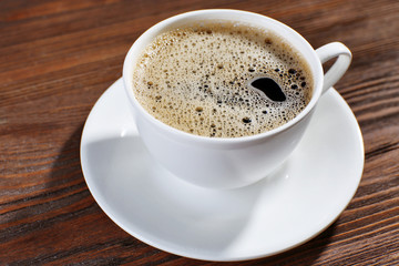 Cup of coffee on wooden background