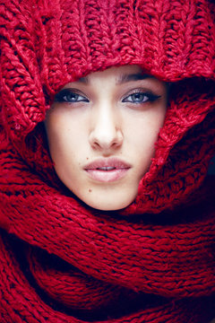 Young Pretty Woman In Sweater And Scarf All Over Her Face