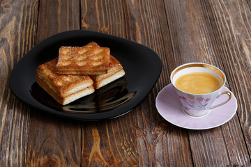 Cookies and cup of coffee on the dark wooden table