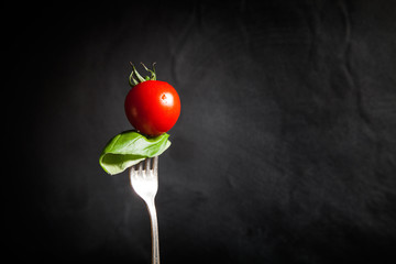 Cherry tomato on fork