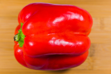 Red bell pepper on wooden table