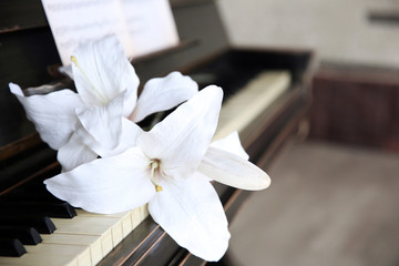 Vintage old classic piano with flower and musical notes, close up