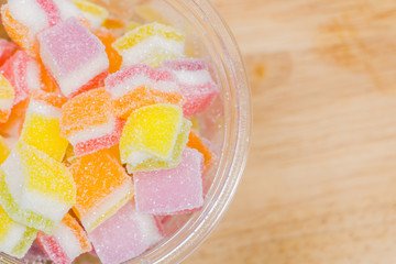 Colorful Gummy candy rainbow on wooden background