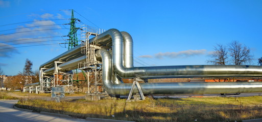 Panoramic view of shining pipes and power transmission tower