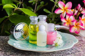 Mini set of bubble bath and shower gel decorated with beautiful flower and plant background for relaxation corner in bathroom