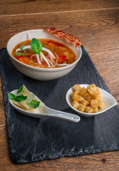 Vegetable soup served with crisp bacon, cheese and croquettes