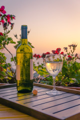 The bottle of wine and glass, cork in the sunset light. Sardinia, Italy. Summer-2015.
