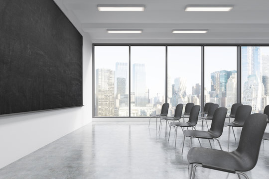 A classroom or presentation room in a modern university or fancy office. Black chairs, a black chalkboard on the wall and panoramic windows with New York view. 3D rendering.