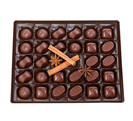Assortment of chocolates in a plastic box close-up isolated on a white background.