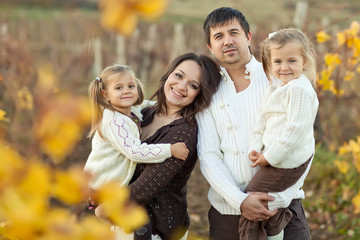 Obraz premium Lovely family are walking in autumn forest