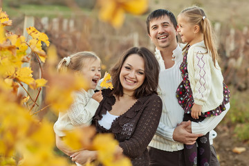 Lovely family are walking in autumn forest