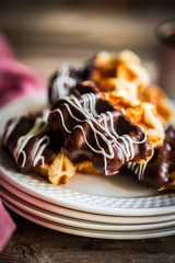 Belgian waffles with chocolate on rustic wooden background