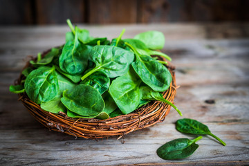 Fresh spinach on rustic wooden background