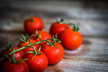 Tomatoes on rustic wooden background