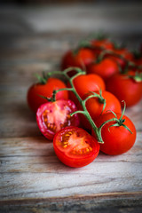 Tomatoes on rustic wooden background