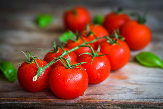 Tomatoes on rustic wooden background